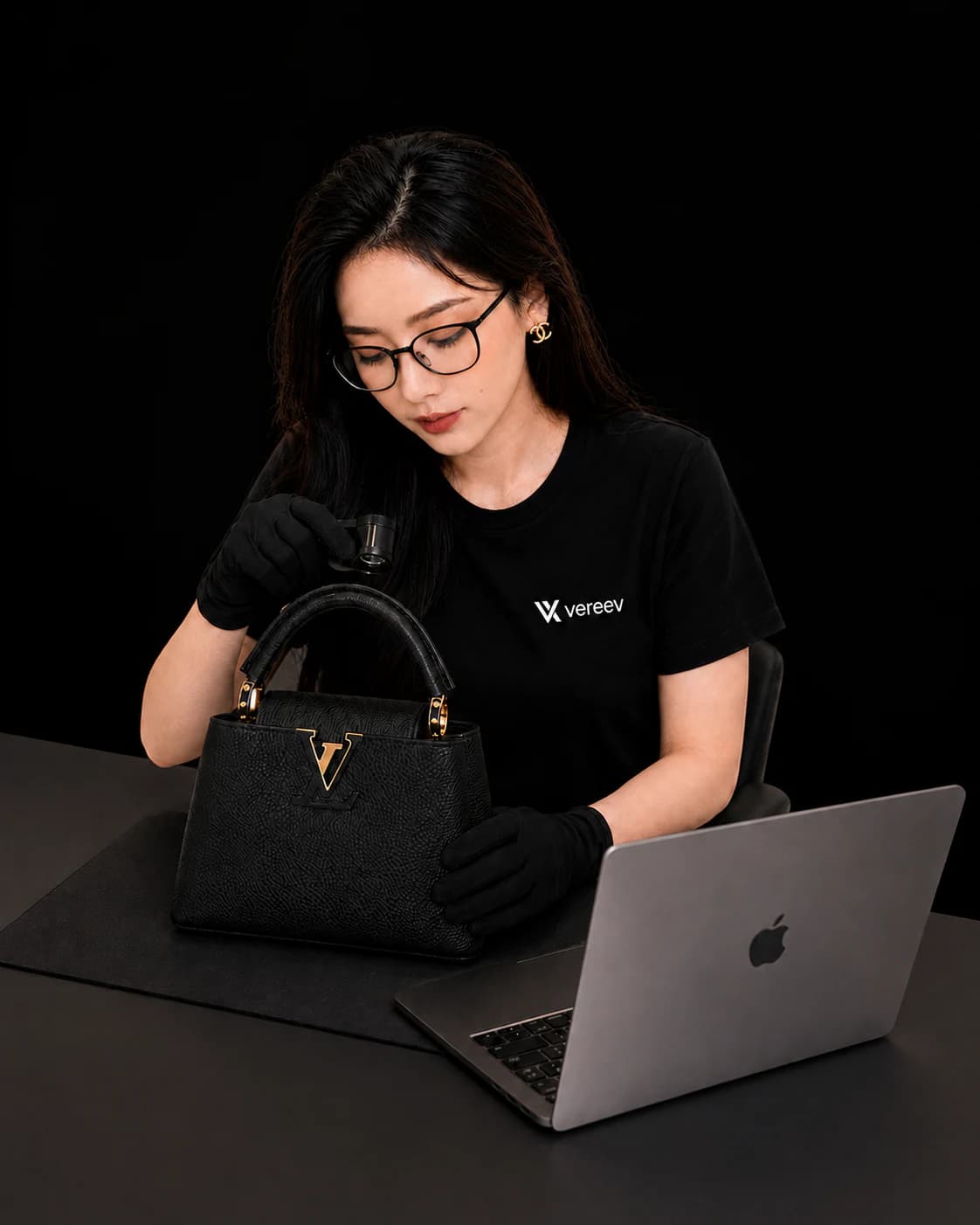Vereev authentication expert inspecting a luxury handbag