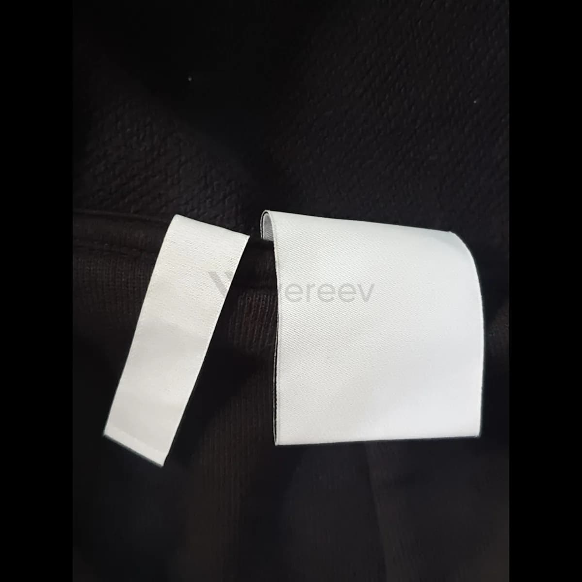 Sample photo 4, Care Label: the white care labels sewn into the side seam of the hoodie