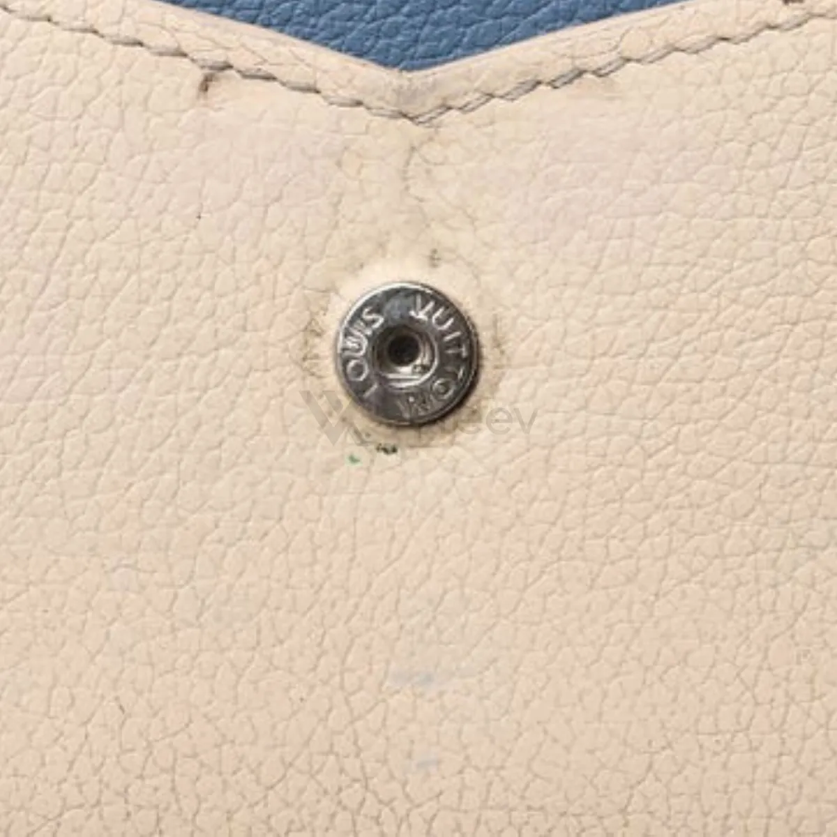 Sample photo 3, Detail: a snap fastener on the cream leather